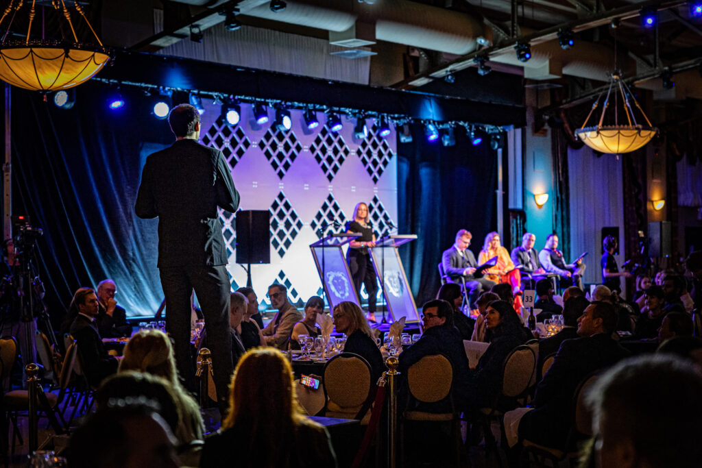 Harvest Systems pitching at the 2024 LiONS LAIR annual gala in front of a crowd
